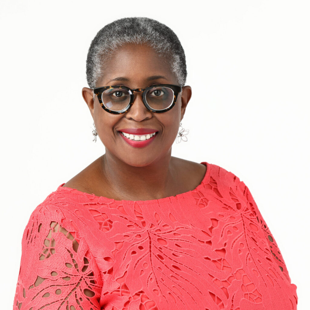 A head-and-shoulders portrait of Gerjuan O'Neal wearing a red dress and glasses.